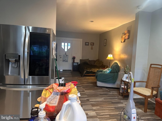 interior space featuring stainless steel fridge with ice dispenser and dark hardwood / wood-style floors