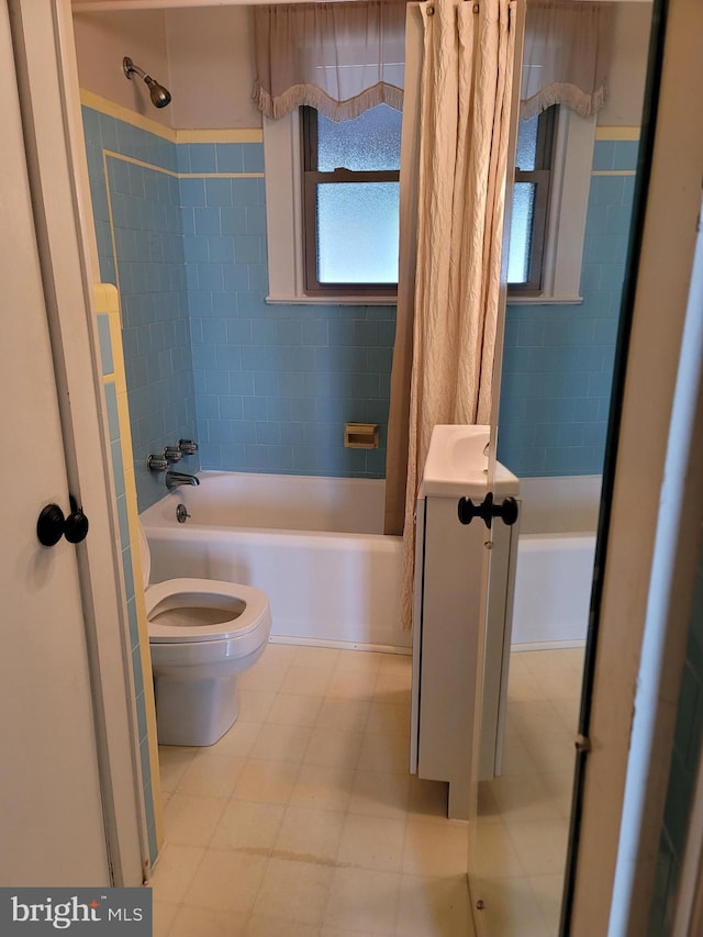 full bathroom featuring vanity, toilet, and shower / bath combination with curtain