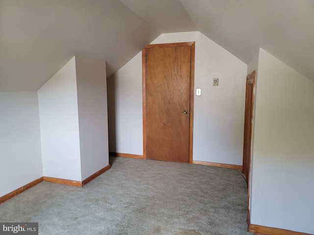 bonus room featuring light carpet and lofted ceiling