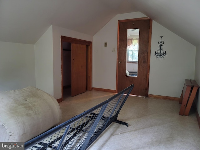 bonus room with vaulted ceiling and light colored carpet