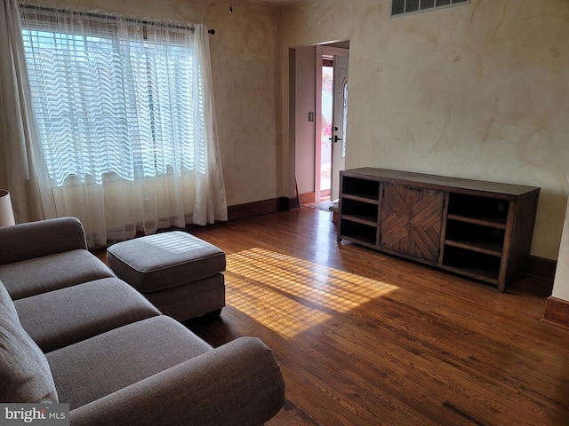 living room with dark hardwood / wood-style flooring