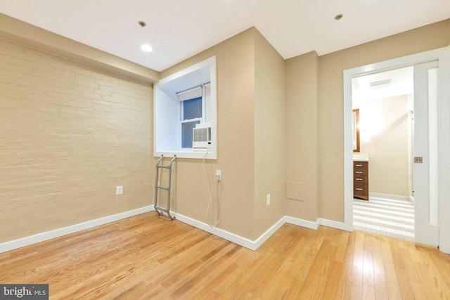 unfurnished room featuring light hardwood / wood-style floors and cooling unit