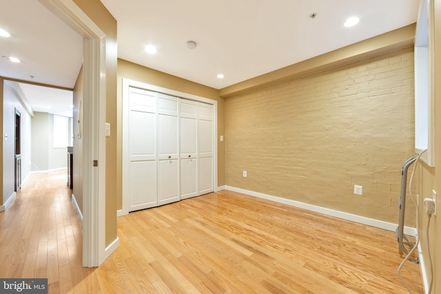 unfurnished bedroom featuring light hardwood / wood-style floors and a closet