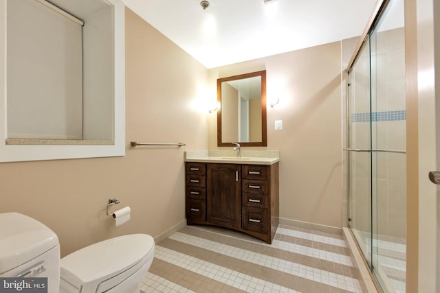 bathroom with tile patterned floors, vanity, toilet, and an enclosed shower