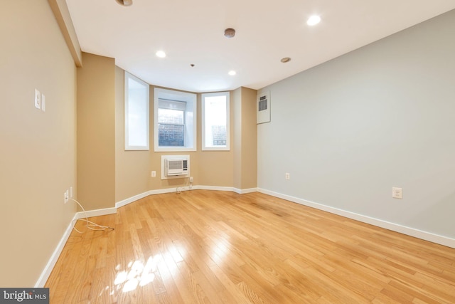 empty room featuring heating unit and light hardwood / wood-style flooring