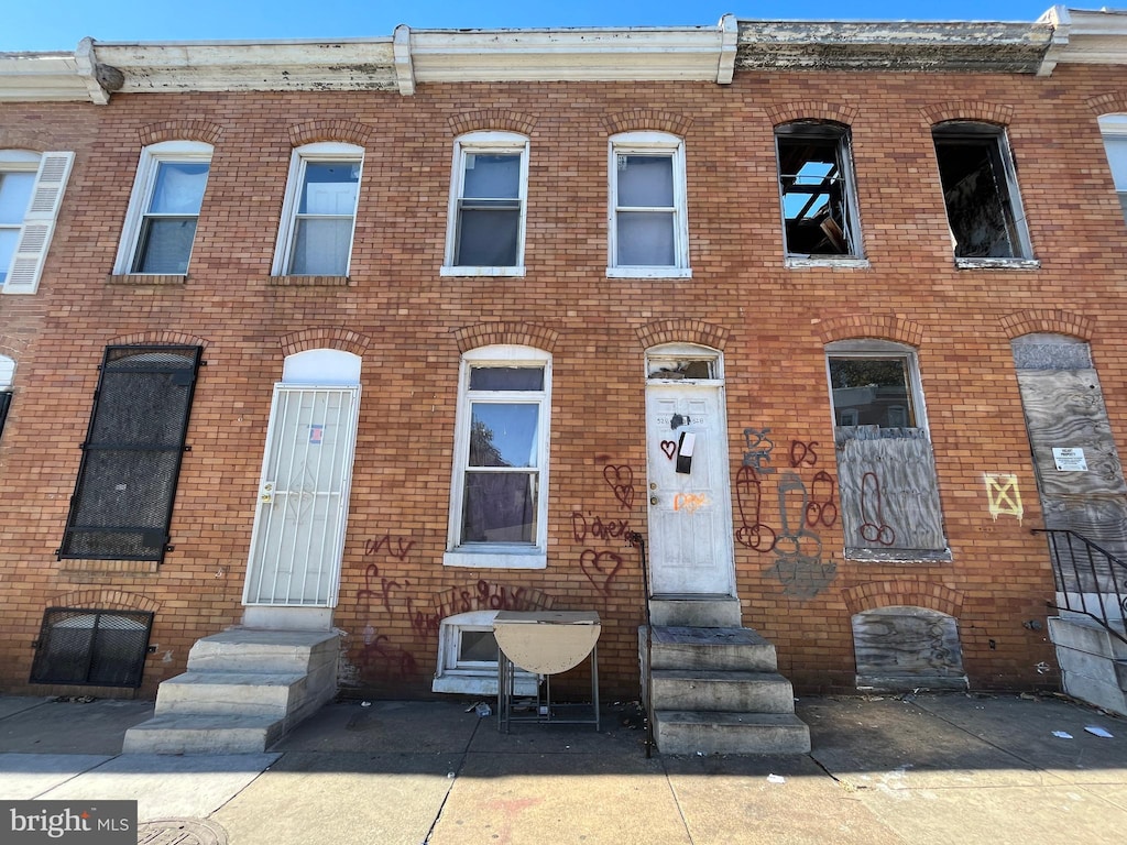 view of property with brick siding and entry steps