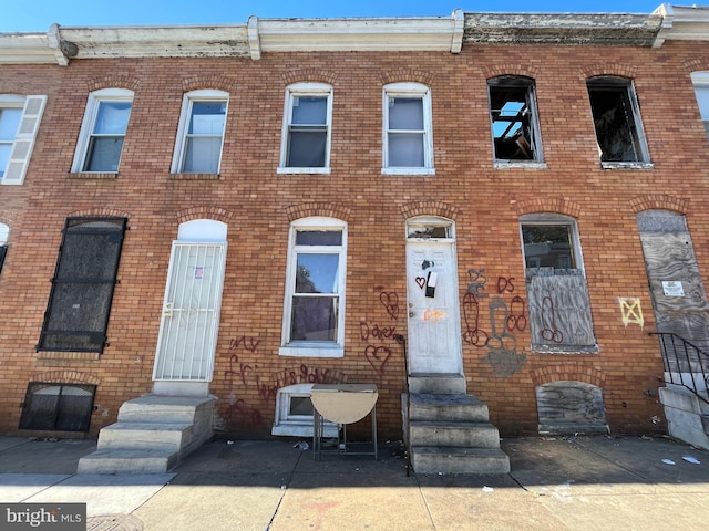 view of property with brick siding and entry steps