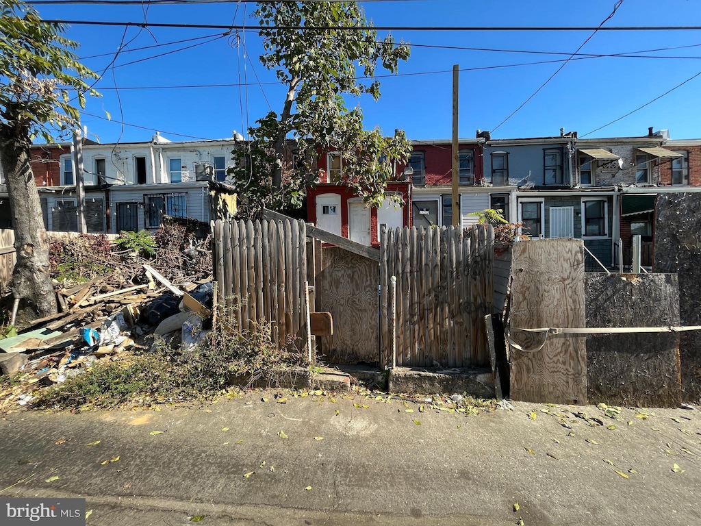 view of front of home featuring fence and a residential view