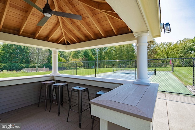 view of patio with exterior bar and tennis court