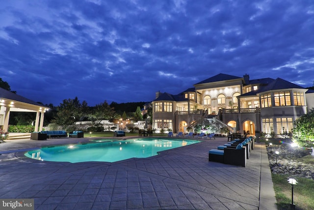 view of pool featuring outdoor lounge area and a patio