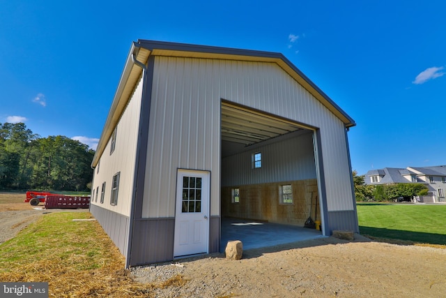 exterior space featuring a garage and a yard