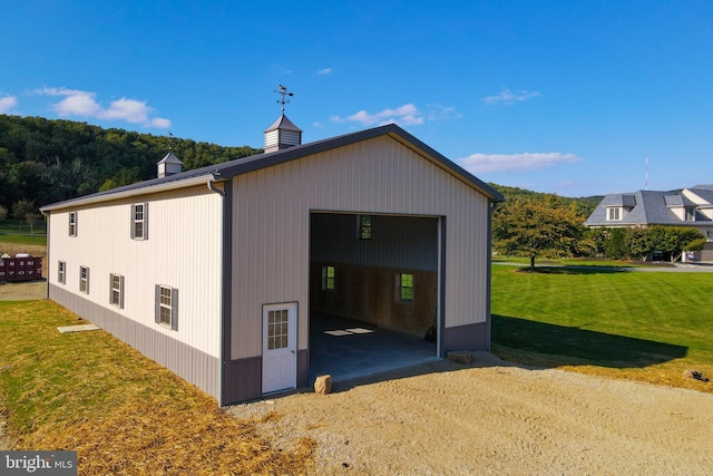 exterior space featuring a garage and a yard