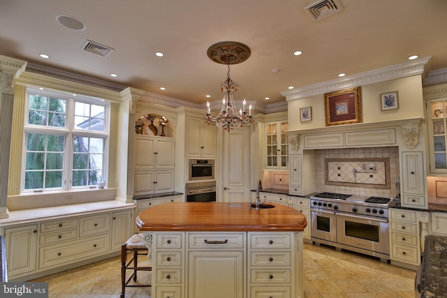 kitchen featuring double oven range, ornamental molding, a kitchen island, pendant lighting, and sink