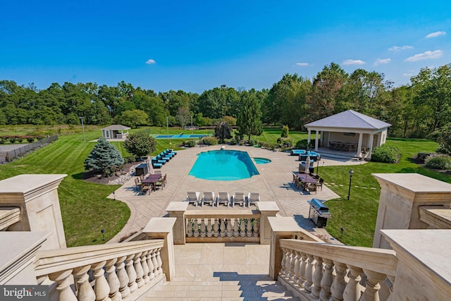 view of swimming pool with a lawn and a patio area