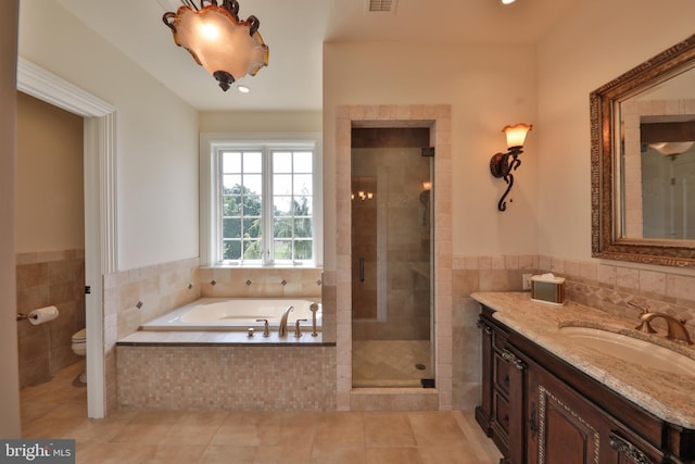 full bathroom with vanity, tile patterned flooring, toilet, and shower with separate bathtub