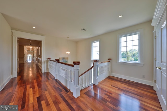 interior space featuring dark wood-type flooring and a notable chandelier