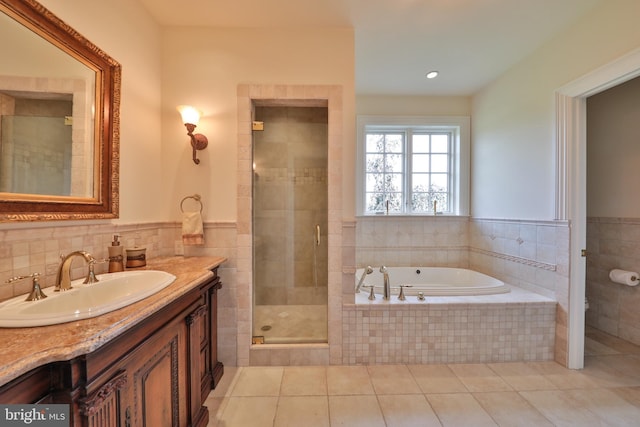 bathroom with walk in shower, vanity, and tile patterned floors