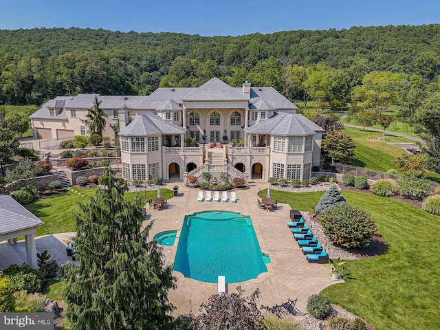 view of pool featuring a diving board and a patio area