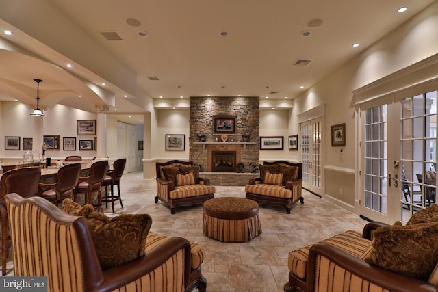 living room with french doors and a fireplace