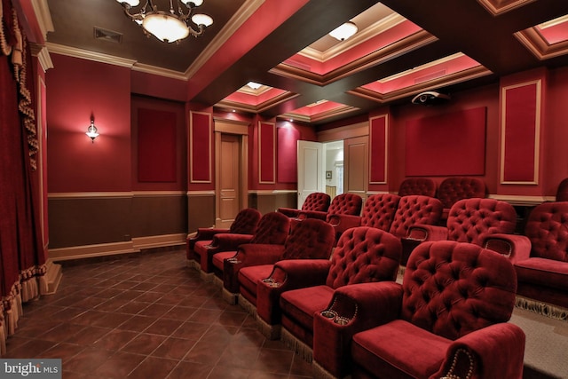 tiled cinema featuring beamed ceiling, a chandelier, crown molding, and coffered ceiling