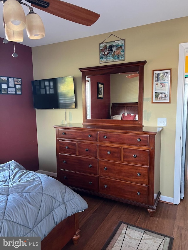 bedroom featuring ceiling fan and dark wood-type flooring