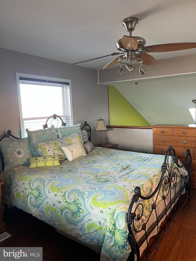 bedroom with dark hardwood / wood-style floors and ceiling fan