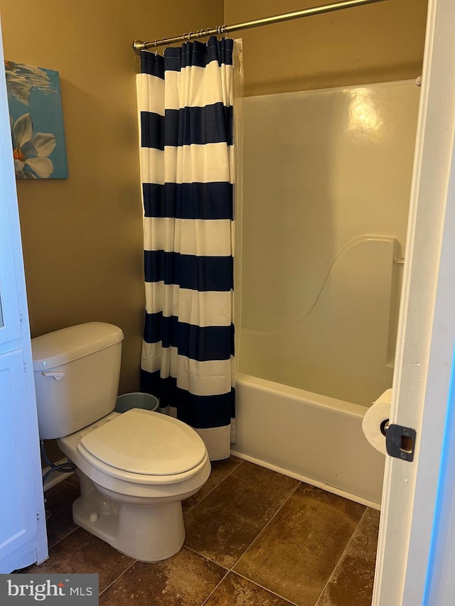 bathroom with shower / bath combination with curtain and toilet