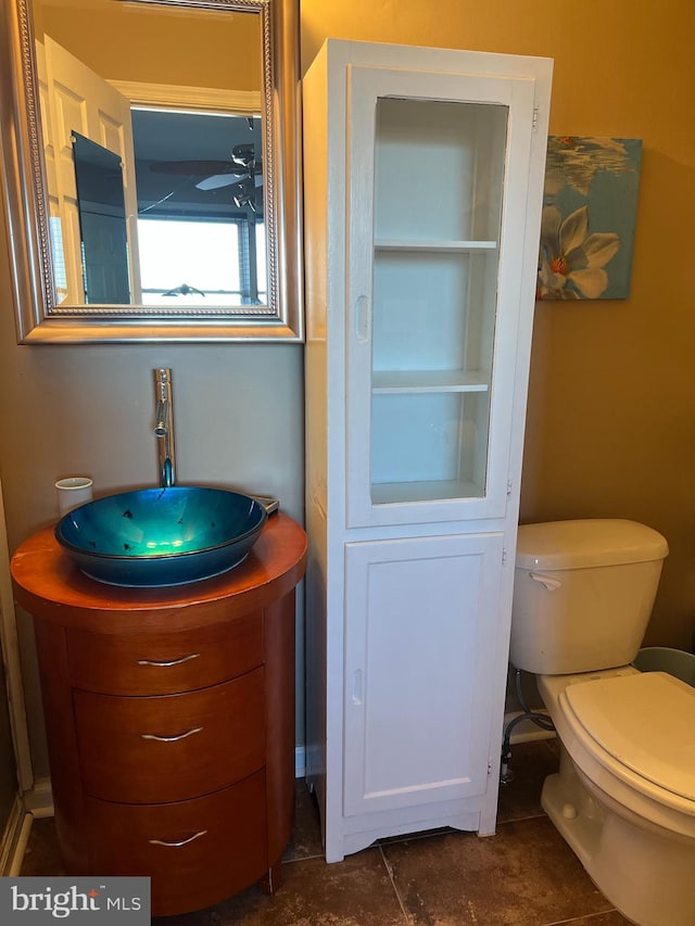 bathroom with tile patterned flooring, vanity, and toilet