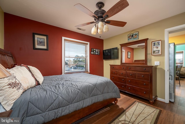 14211 Dukes Ave Unit 203, Ocean City, MD 21842 - bedroom with wood finished floors, ceiling fan, and baseboards