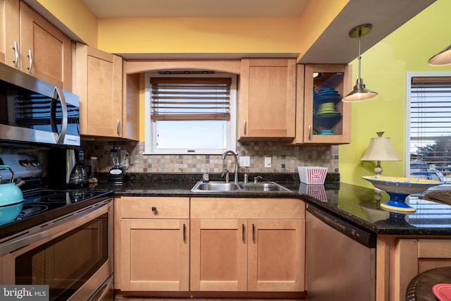 kitchen with backsplash, plenty of natural light, sink, and appliances with stainless steel finishes