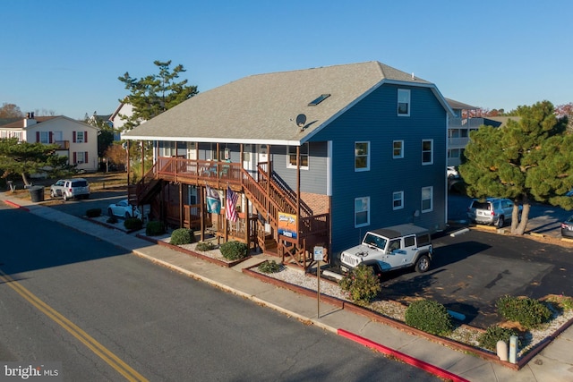 14211 Dukes Ave Unit 203, Ocean City, MD 21842 - view of front of property featuring stairs and a shingled roof