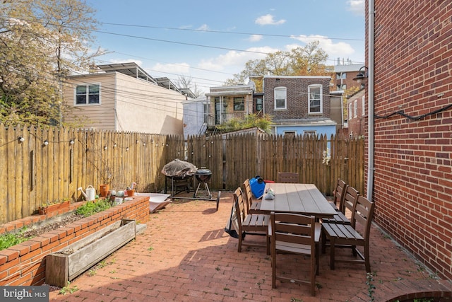 view of patio featuring outdoor dining space and a fenced backyard