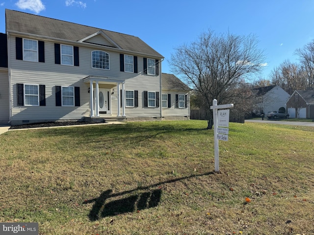 colonial home featuring a front yard