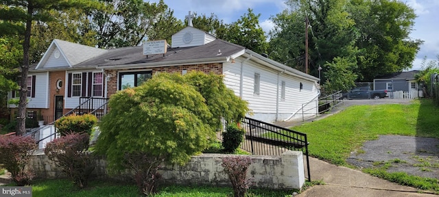 607 62nd Ave, Fairmount Heights, MD 20743 - view of front of home with a front lawn, brick siding, and fence