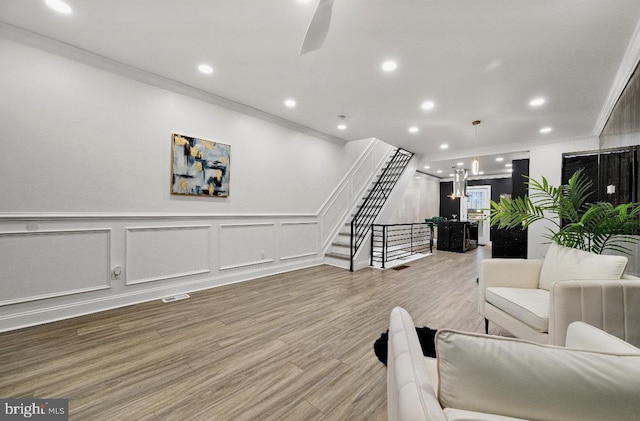 living room with ornamental molding and hardwood / wood-style floors