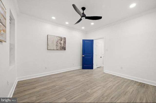 empty room with ornamental molding, light hardwood / wood-style flooring, and ceiling fan