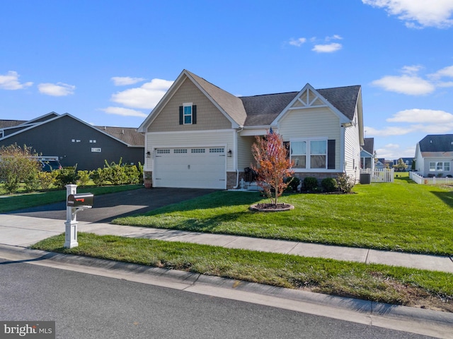 craftsman inspired home with a front yard and a garage