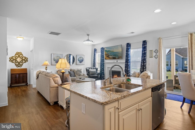 kitchen with hardwood / wood-style flooring, sink, stainless steel dishwasher, and a kitchen island with sink