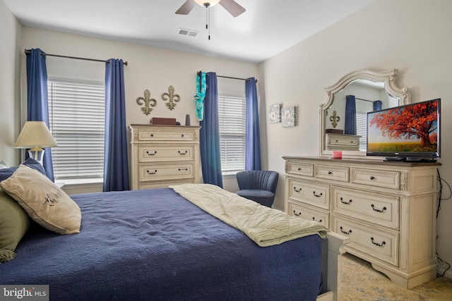 bedroom featuring ceiling fan and carpet