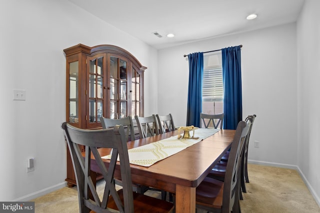 dining room featuring light colored carpet