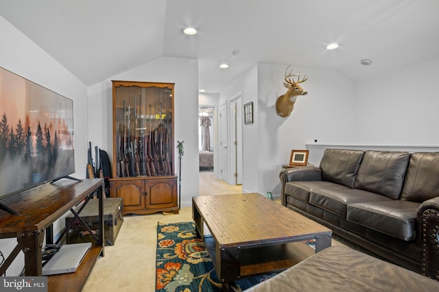 living room with vaulted ceiling and light colored carpet