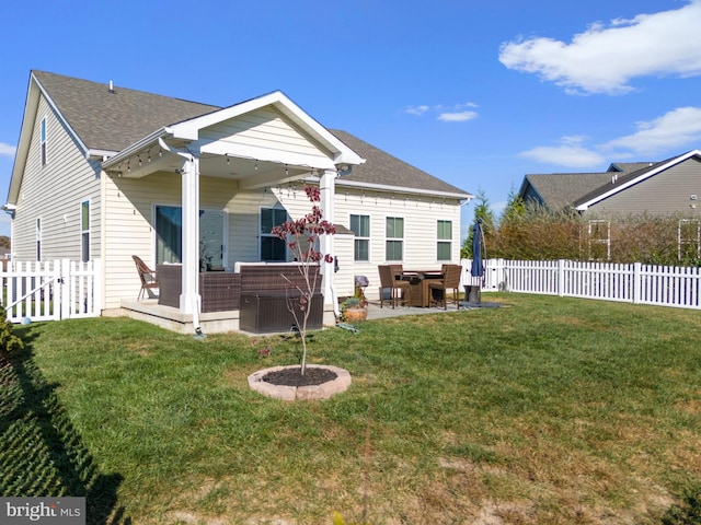 rear view of house featuring a patio area and a lawn