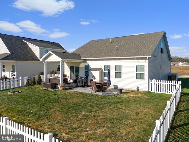 rear view of house with a patio area and a lawn