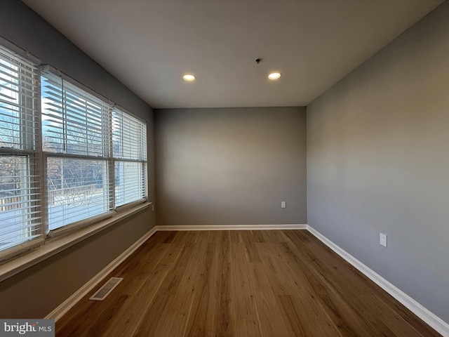 unfurnished room with hardwood / wood-style floors