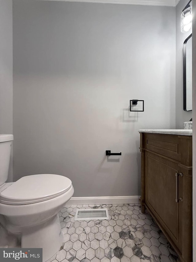 bathroom featuring tile patterned flooring, vanity, and toilet