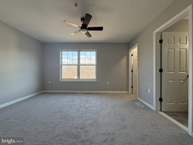 empty room featuring light carpet and ceiling fan