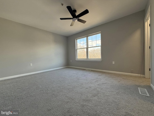 empty room featuring carpet flooring and ceiling fan