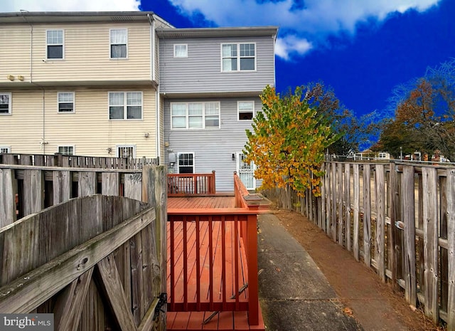 back of house featuring a wooden deck