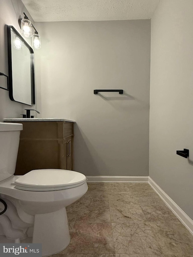 bathroom featuring a textured ceiling and toilet