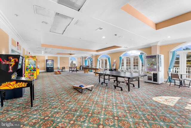 playroom featuring french doors, a tray ceiling, carpet, and crown molding